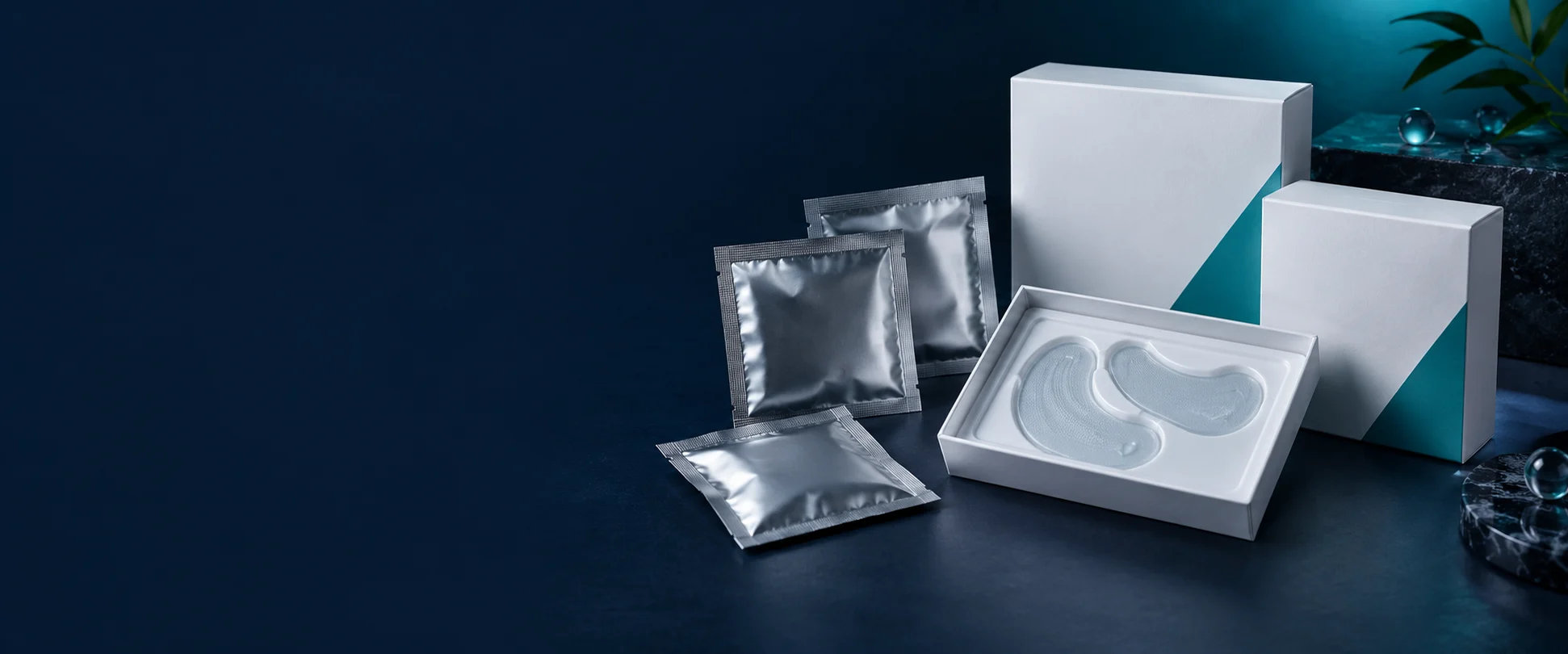 Private-label white cartons and silver pouches with paired under-eye patch samples